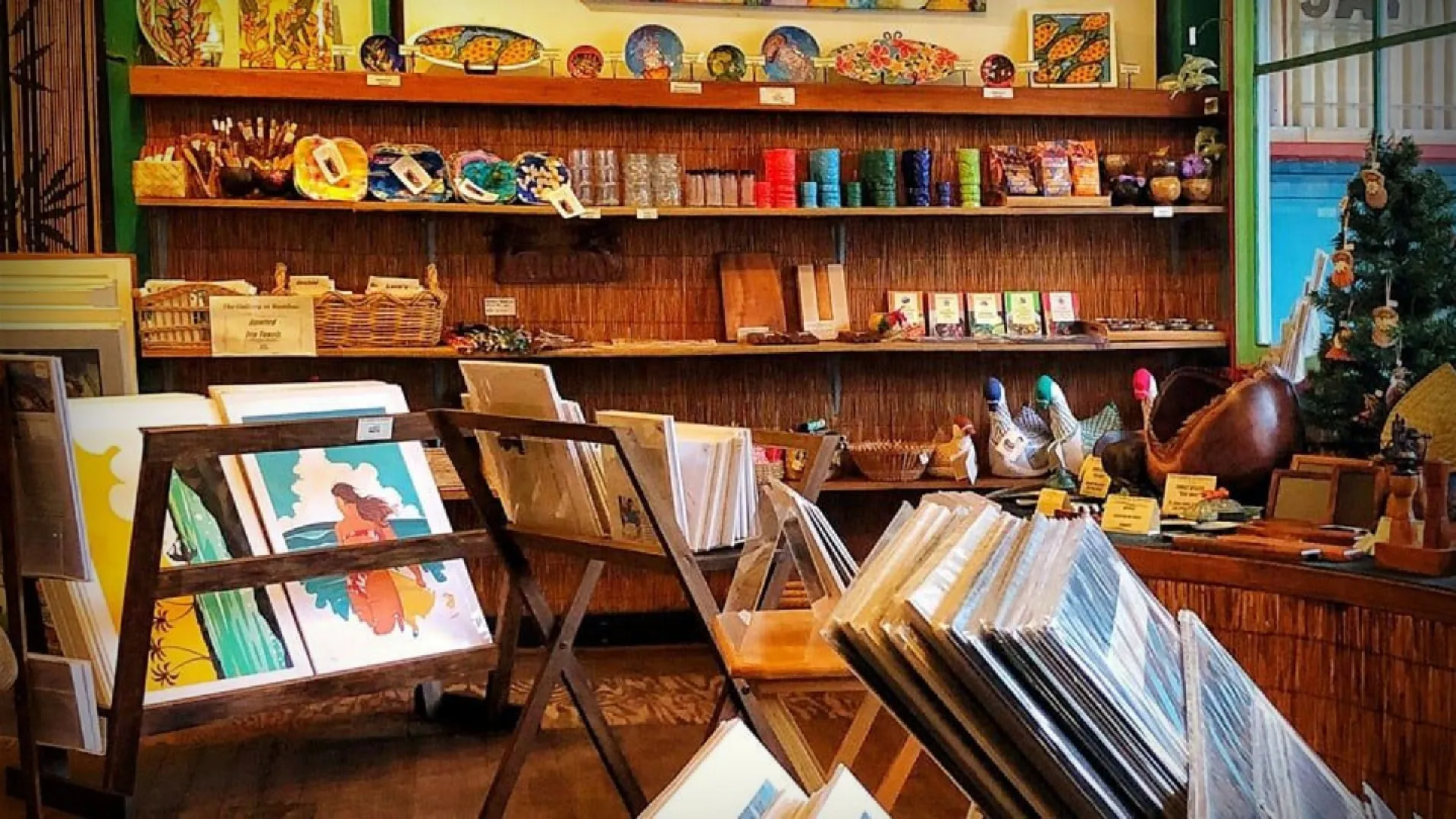 Art store interior with framed prints, colorful pottery, and decorative items on display.